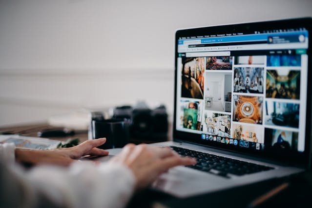 Person looking at images on a laptop. Website copywriting and editing services
