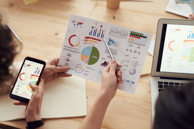 Print out, laptop and mobile phone graphs and charts. Marketing analytics and dashboards services Charity Digital Marketing