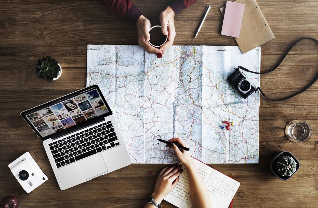 Top down view of a map and a laptop. Email journey design and copywriting services Charity Digital Marketing
